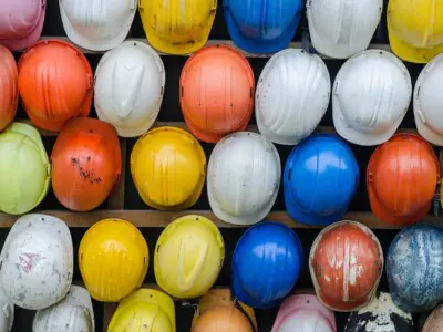 A wall of rainbow hard hats