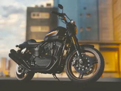 Motorcycle with no rider parked with a cityscape behind it.