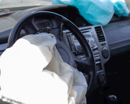 A deployed airbag in a car steering wheel.
