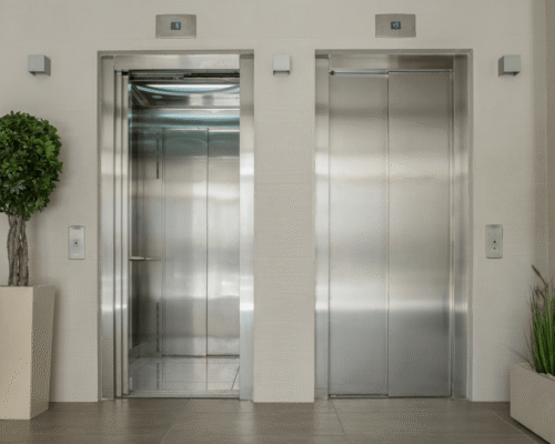 Two modern, stainless steel elevator doors, one open and one closed, representing the risk of a Bronx elevator violation injury.