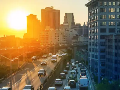 View of rush hour traffic on the Brooklyn Queens Expressway in New York City with sunset light in background