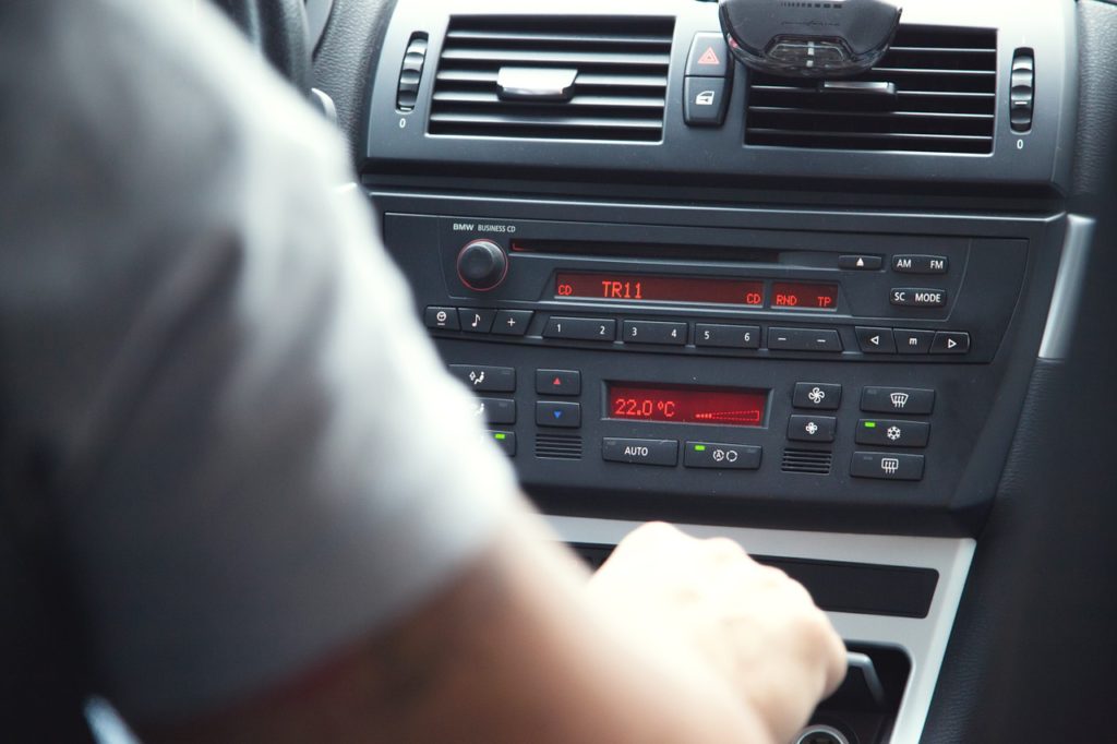 car stereo-radio-driver-distracted-music-listening-changing stations