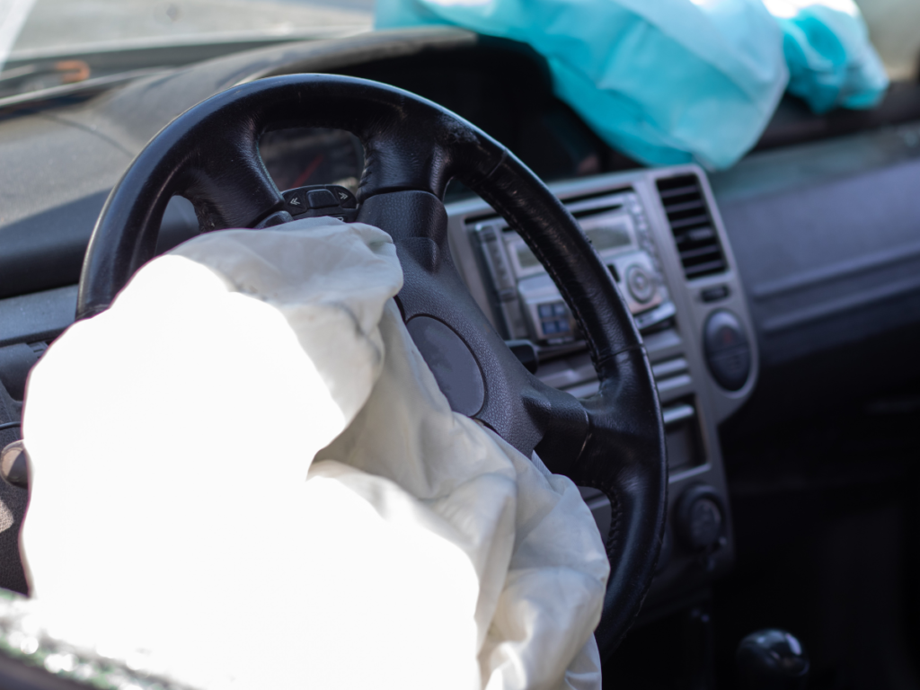 A deployed airbag in a car steering wheel.